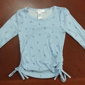 A light blue long sleeve crop top